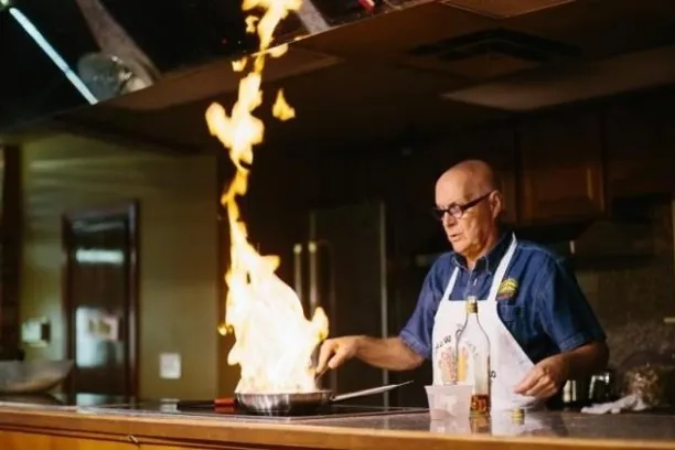 a man standing in front of a table
