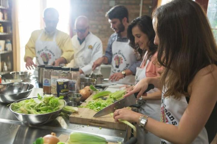 a group of people preparing food in a kitchen