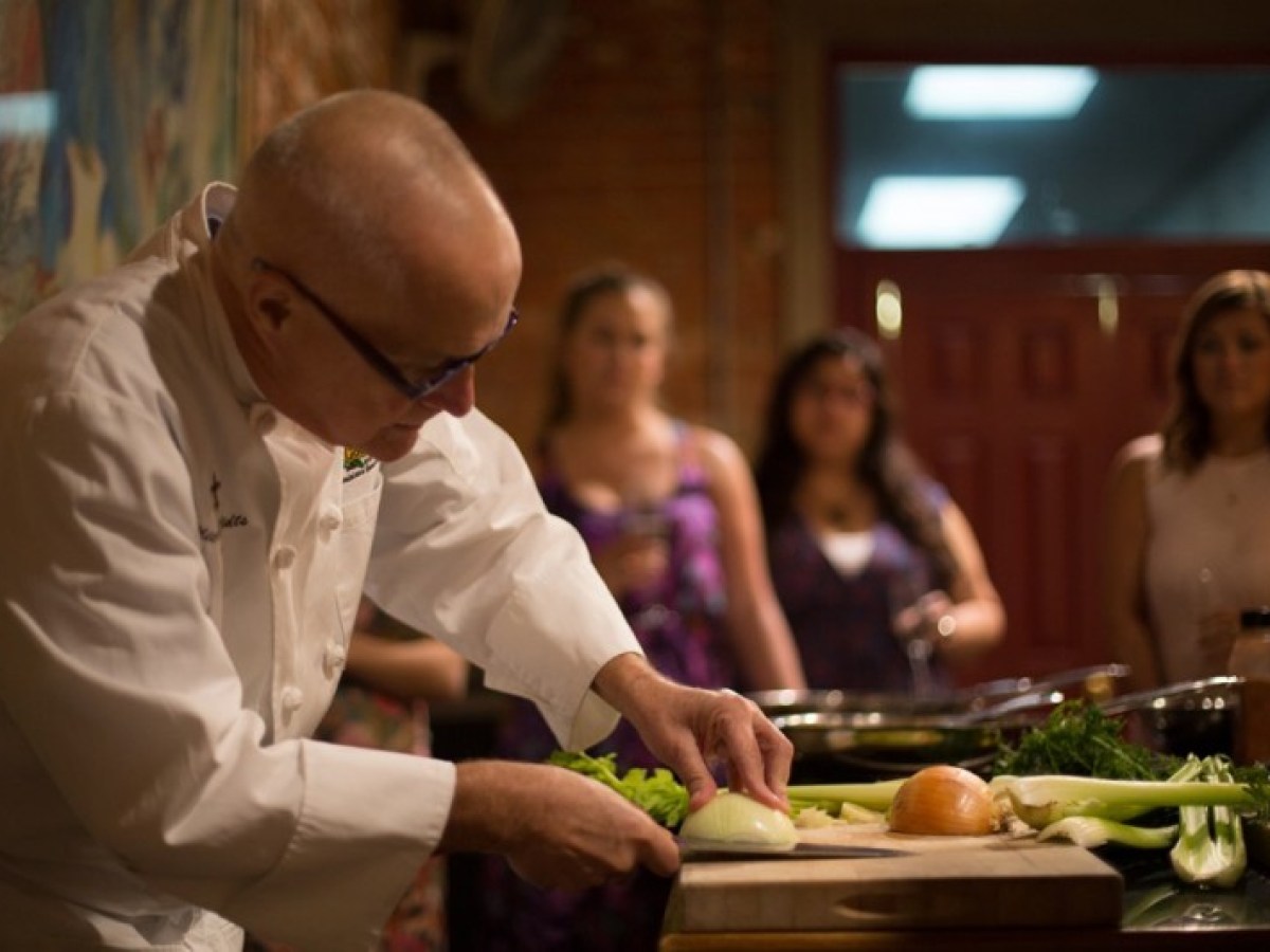 a group of people preparing food on a table