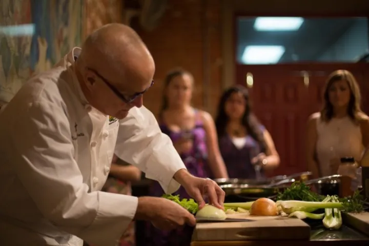 a group of people preparing food on a table