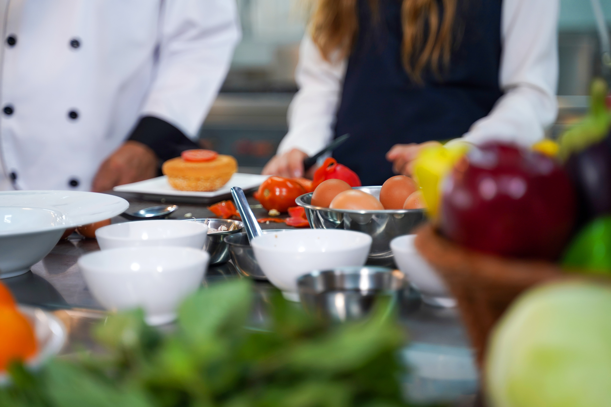 Chef preparing student for learning marking and cooking food at workshop.