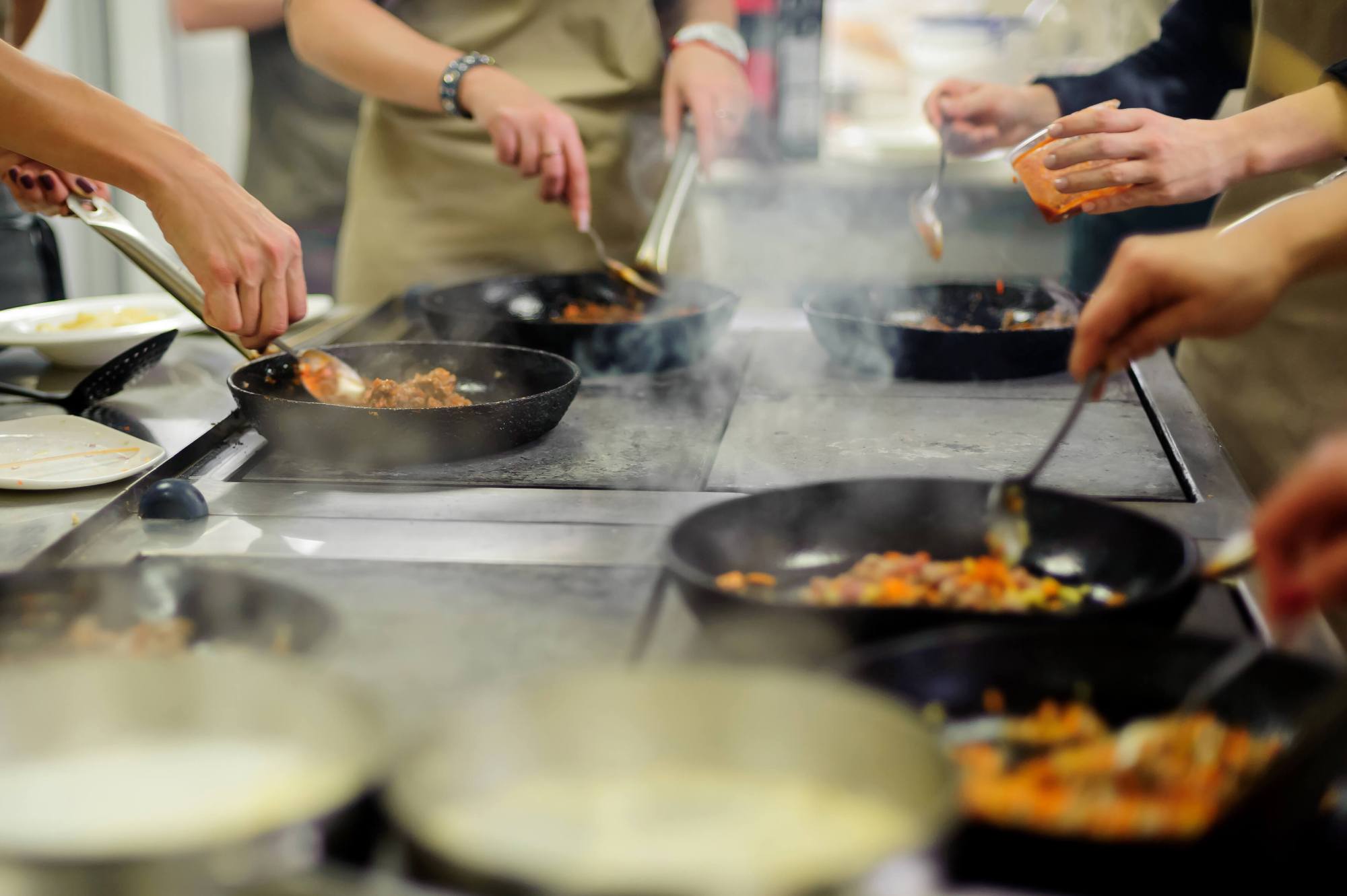 iStock-1268900953 (1) Pots on a stove in a group cooking class